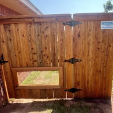 Perfectly-Crafted-customized-fence-installation-in-Midwest-City-Complete-with-a-personalized-dog-window-and-stainseal 0